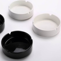 Deep round-cavity ashtray with a glossy solid-black glaze