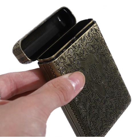 Luxurious vintage-style gold-tone metal cigarette case with ornate engravings