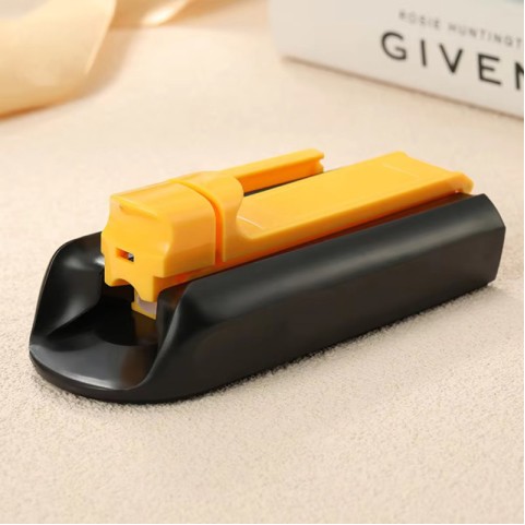 Portable manual cigarette roller in a yellow and black color scheme