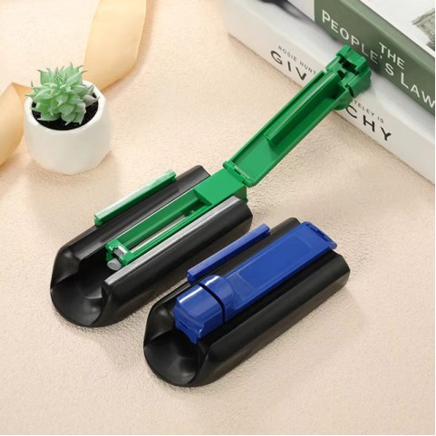 Portable manual cigarette roller in a yellow and black color scheme